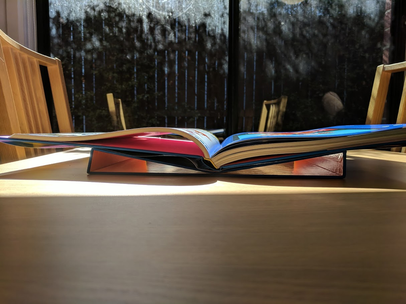 The outer cover folds in the middle to create this reading stand, which is something I will now hope for/expect from every fancy video game book.